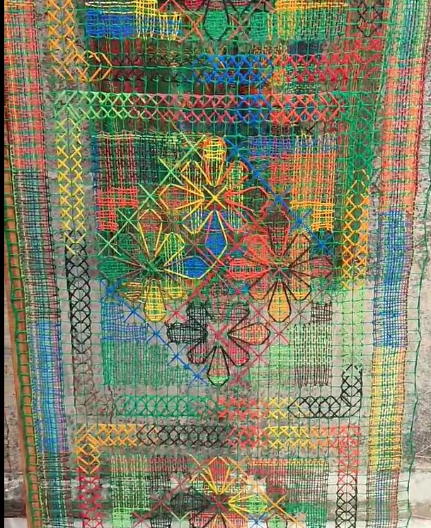 Renda de filé net embroidery from Jaguaribe in bright green, yellow, red and blue geometric patterns